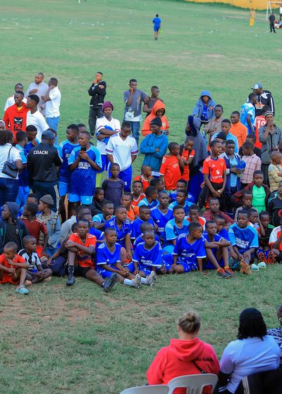 spectators watching a match from the sideline