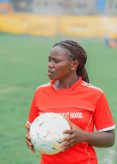 the Kigezi Women Football Tournament trophy and sponsor banner